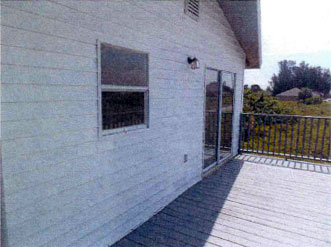 AHF rehab property in Lehigh Acres, FL. View of deck entrance.