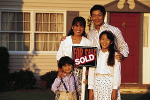 family in front of newly purchased home