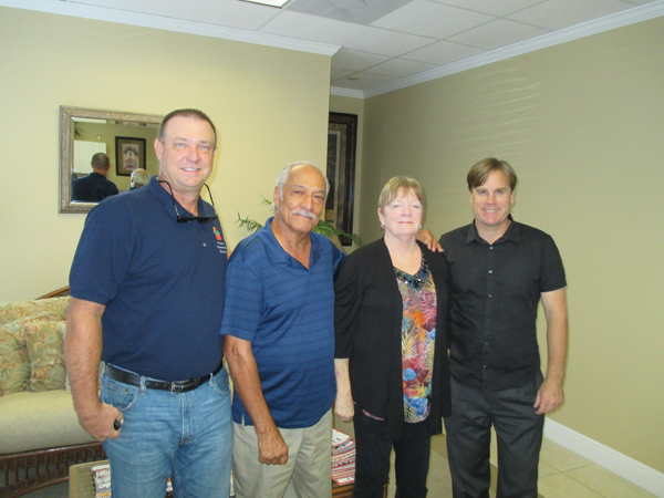 New home owners through the AHF Homes For Vets program, Errol & Joann Heath With Realtors Ken Falvey & Squire Wells.